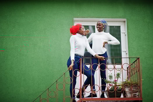 Two young modern fashionable, attractive, tall and slim african muslim womans in hijab or turban head scarf posed together. photo