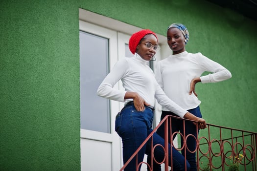 Two young modern fashionable, attractive, tall and slim african muslim womans in hijab or turban head scarf posed together. photo