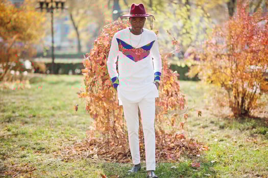 Stylish trendy afro france man in red hat and white outfit posed at autumn day. Black african model guy. photo