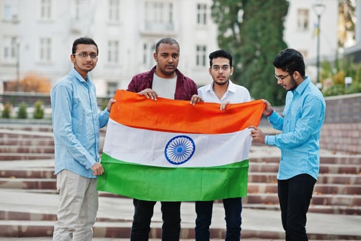 Group of four south asian indian male with India flag. photo