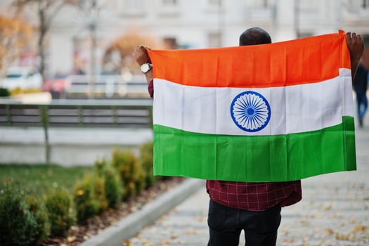 South asian indian male student with India flag posed outdoor. photo