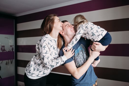 Mom, Dad and little girl having fun together photo