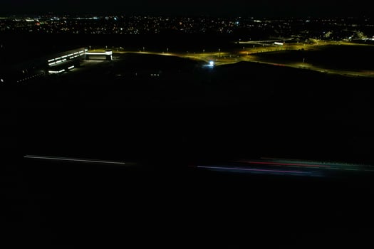 Night Aerial View of British Motorways with illuminated Roads and Traffic. Highways footage taken with drone's camera over Milton Keynes and motorways of England at Dark Night photo