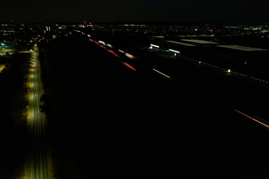 Night Aerial View of British Motorways with illuminated Roads and Traffic. Highways footage taken with drone's camera over Milton Keynes and motorways of England at Dark Night photo