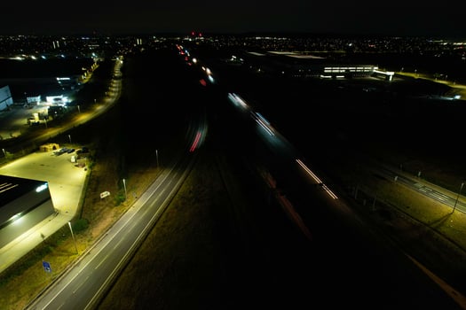 Night Aerial View of British Motorways with illuminated Roads and Traffic. Highways footage taken with drone's camera over Milton Keynes and motorways of England at Dark Night photo