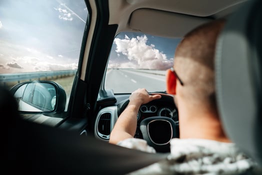 The man in the car traveling on the road photo