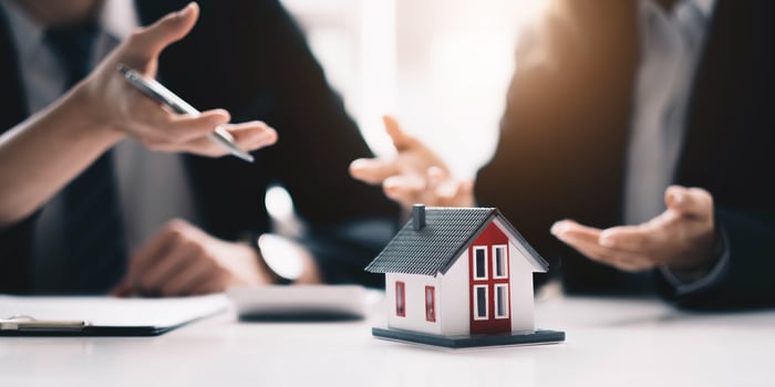 Real estate broker agent presenting and consult to customer to decision making sign insurance form agreement, buy and sell home model, concerning mortgage loan offer for and house insurance photo