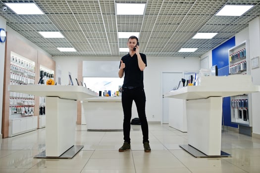 Seller man mobile phone professional consultant in tech store or shop. photo