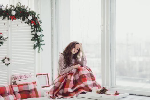 woman sitting in plaid by the window photo
