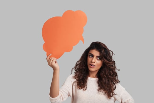 New ideas. Thoughtful young woman looking away while standing against grey background photo