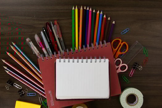 Red Books with color pencils and education elements, back to school concepts on dark wood background. used in poster, brochures photo