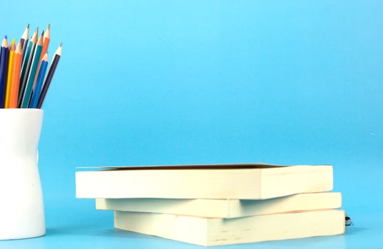 Back to School concepts with books, pens, pencils on light blue background. used in Back to school poster, brochure photo