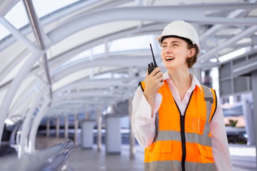 Caucasian woman engineer is using walkie talkie while inspecting the construction project for modern architecture and real estate development concept photo