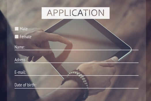 Apply now. Close-up top view of man working on digital tablet with digitally composed application form over it photo