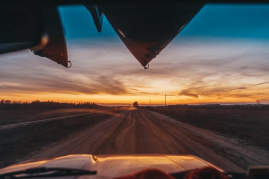 SUV driving on a dirt road view through the windshield photo