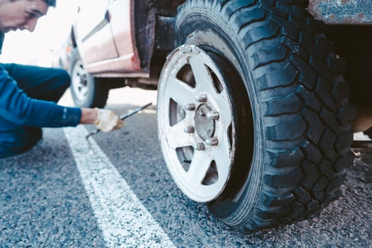 Man change the wheel manually on a 4x4 off road truck photo