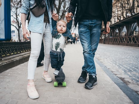 Mom dad and little son together on a walk photo