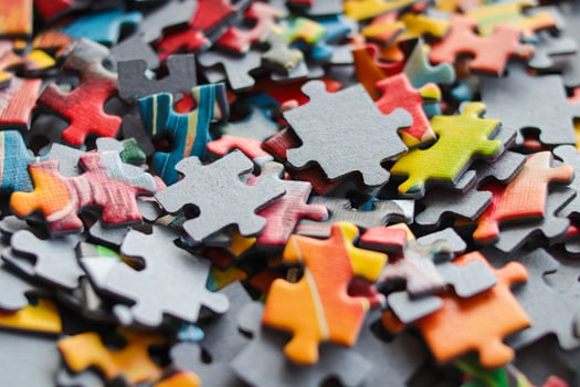 Multicolored puzzles. Family game. Concept of putting together disconnected elements.Puzzle background photo