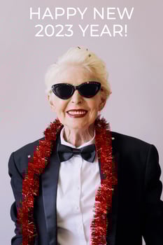 Beautiful stylish mature senior woman in sunglasses and tuxedo celebrating new year. Fun, party, style, celebration concept photo