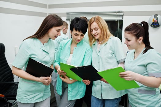 Medical theme.Observation room with a computer tomograph. The group of female doctors with clipboards meeting in the mri office at diagnostic center in hospital. photo