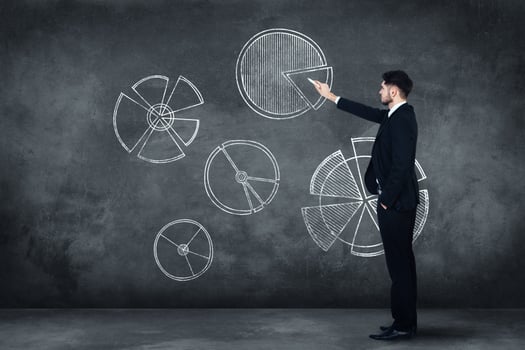 Planning strategy. Full length of confident young man in full suit standing near concrete wall and drawing diagram on it photo