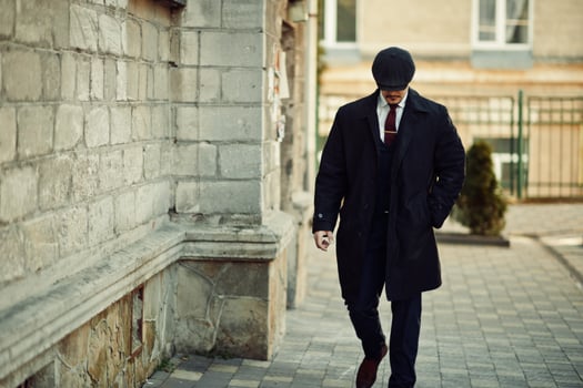 Portrait of retro 1920s english arabian business man wearing dark suit, tie and flat cap. photo