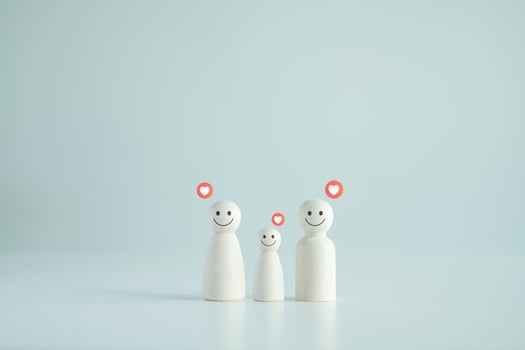 Wooden figure family happy face with heart, family home. Family relationship symbol. Insurance and property investment, homeless support, world mental health day. photo