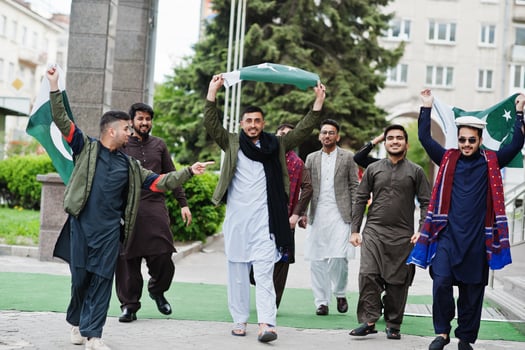 Group of pakistani man wearing traditional clothes salwar kameez or kurta with Pakistan flags. photo