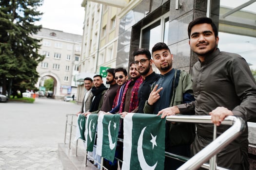 Group of pakistani man wearing traditional clothes salwar kameez or kurta with Pakistan flags. photo