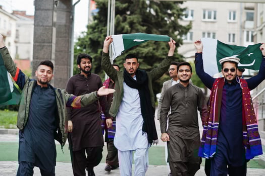 Group of pakistani man wearing traditional clothes salwar kameez or kurta with Pakistan flags. photo