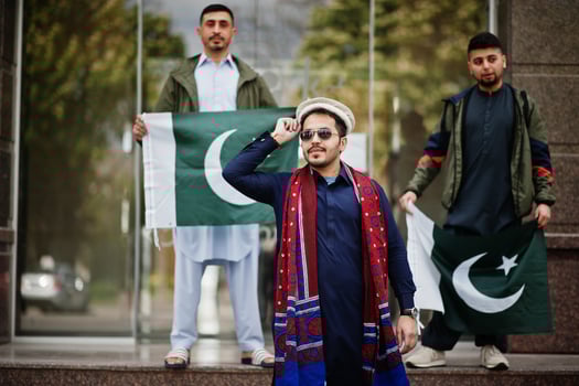 Group of pakistani man wearing traditional clothes salwar kameez or kurta with Pakistan flags. photo