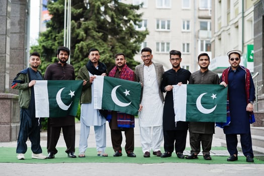 Group of pakistani man wearing traditional clothes salwar kameez or kurta with Pakistan flags. photo