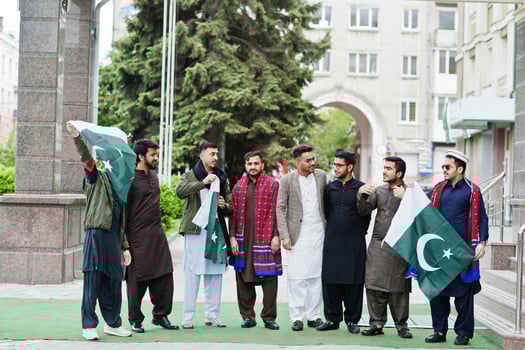 Group of pakistani man wearing traditional clothes salwar kameez or kurta with Pakistan flags. photo