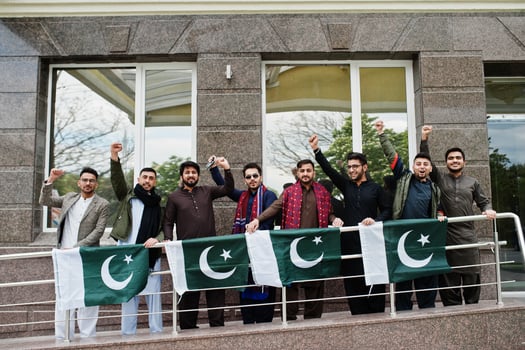 Group of pakistani man wearing traditional clothes salwar kameez or kurta with Pakistan flags. photo