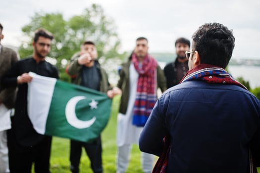 Group of pakistani man wearing traditional clothes salwar kameez or kurta with Pakistan flags. photo