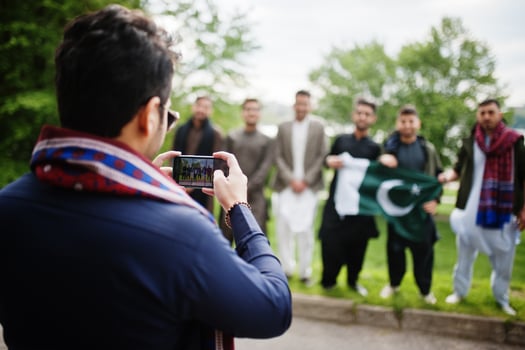 Group of pakistani man wearing traditional clothes salwar kameez or kurta with Pakistan flags. photo