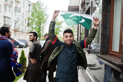 Group of pakistani man wearing traditional clothes salwar kameez or kurta with Pakistan flags. photo