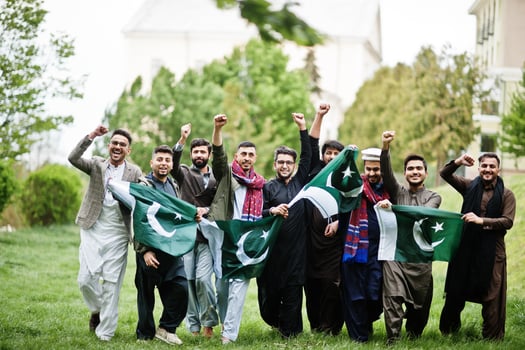 Group of pakistani man wearing traditional clothes salwar kameez or kurta with Pakistan flags. photo