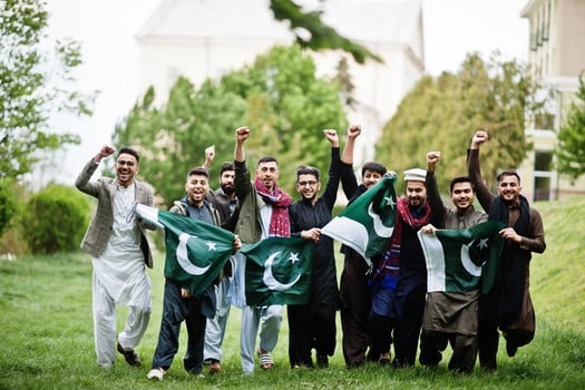 Group of pakistani man wearing traditional clothes salwar kameez or kurta with Pakistan flags. photo