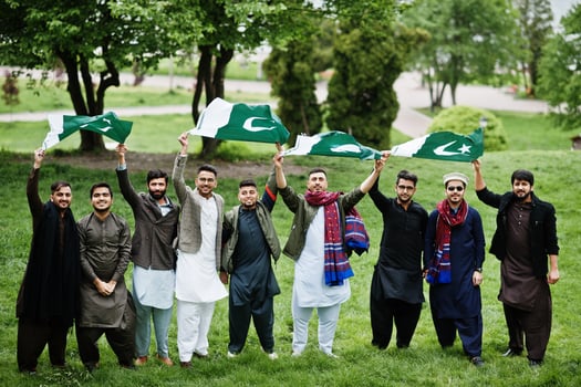 Group of pakistani man wearing traditional clothes salwar kameez or kurta with Pakistan flags. photo
