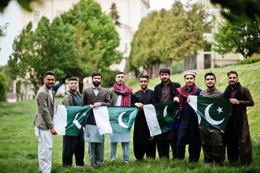 Group of pakistani man wearing traditional clothes salwar kameez or kurta with Pakistan flags. photo