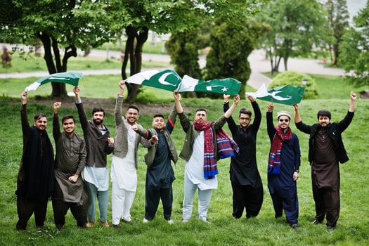 Group of pakistani man wearing traditional clothes salwar kameez or kurta with Pakistan flags. photo