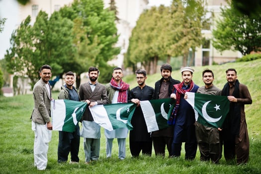 Group of pakistani man wearing traditional clothes salwar kameez or kurta with Pakistan flags. photo