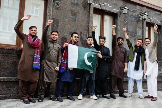 Group of pakistani man wearing traditional clothes salwar kameez or kurta with Pakistan flags. photo