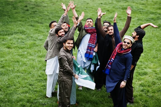 Group of pakistani man wearing traditional clothes salwar kameez or kurta with Pakistan flags. photo