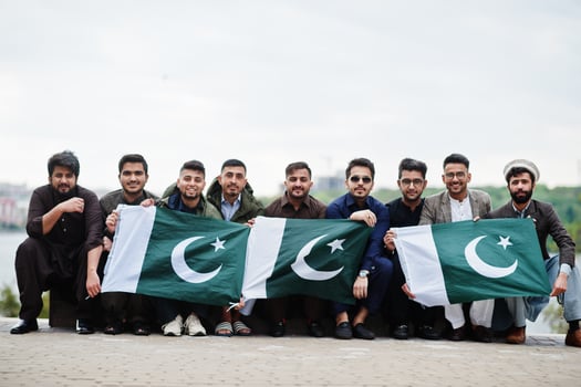 Group of pakistani man wearing traditional clothes salwar kameez or kurta with Pakistan flags. photo