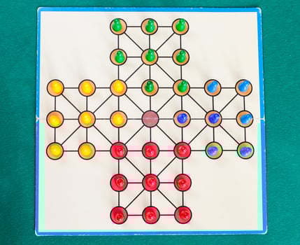 setup of solitaire board game on green baize table photo