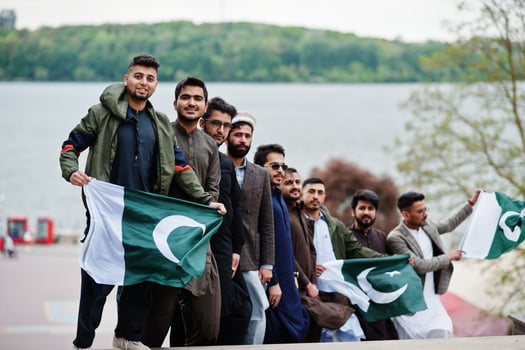 Group of pakistani man wearing traditional clothes salwar kameez or kurta with Pakistan flags. photo