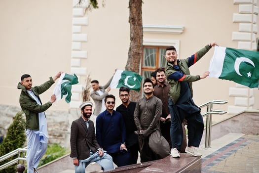 Group of pakistani man wearing traditional clothes salwar kameez or kurta with Pakistan flags. photo