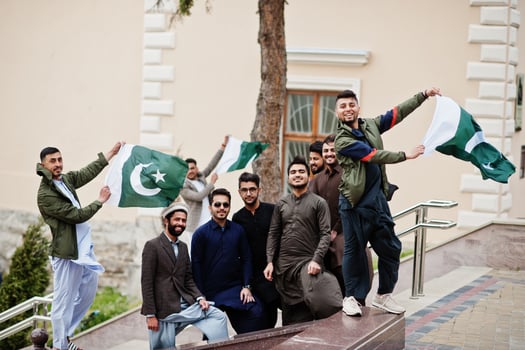 Group of pakistani man wearing traditional clothes salwar kameez or kurta with Pakistan flags. photo